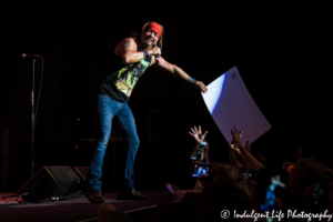 Bret Michaels grabbing a front-row fan's sign during his concert at Star Pavilion inside of Amerstar Casino Hotel Kansas City on November 11, 2017 | Ameristar Casino Events - Bret Michaels Band - Veterans Day 2017