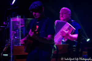 Bass guitarist Paul Guzzone with accordion player Joe Mennonna of The Bacon Brothers live at VooDoo Lounge inside of Harrah's Casino in Kansas City, MO on July 14, 2018.