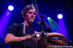 Kevin Bacon playing the bongo drums live at VooDoo Lounge inside of Harrah's North Kansas City Hotel & Casino on July 14, 2018.