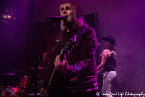 Frontman Mike Peters of The Alarm performing with wife Jules Peters on keyboards and drummer Smiley at recordBar in Kansas City, MO on November 7, 2018.