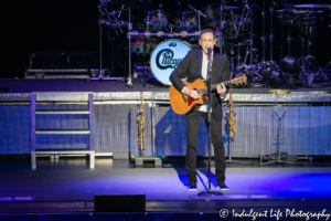 Chicago lead singer Neil Donnell playing the acoustic guitar at Starlight Theatre in Kansas City, MO on May 19, 2019.