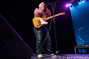 Singer and musician Nick Sibley of The Ozark Mountain Daredevils playing the harmonica at Star Pavilion inside Ameristar Casino Hotel Kansas City on May 18, 2019.