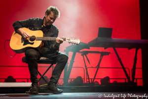 Robin Boult playing "No One is to Blame" on the acoustic guitar during Howard Jones' "Transform" tour stop at Star Pavilion inside of Ameristar Casino in Kansas City, MO on June 22, 2019.