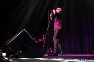 Lead singer Ivan Doroschuk of Men Without Hats with keyboard players Louise Porter and Rachel Ashmore at Star Pavilion inside Ameristar Casino in Kansas City, MO on June 22, 2019.