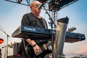 A Flock of Seagulls founder Mike Score singing and playing the guitar live at Sunset Music Fest on the Town Center Plaza in Leawood, KS on June 27, 2019.