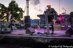 Lead singer and keyboardist Mike Score, drummer Kevin Rankin and bass player Pando of A Flock of Seagulls in concert together at Town Center Plaza's Sunset Music Fest in Leawood, KS on June 27, 2019.