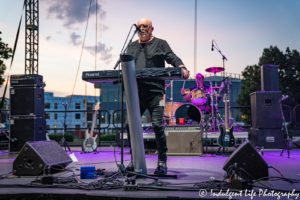 A Flock of Seagulls lead singer and keyboardist Mike Score and drummer Kevin Rankin performing together at Sunset Music Fest on the Town Center Plaza in Leawood, KS on June 27, 2019.