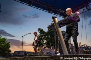 A Flock of Seagulls bandmates Mike Score on the keyboard and Pando on bass guitar together in concert at Town Center Plaza's Sunset Music Fest on June 27, 2019.
