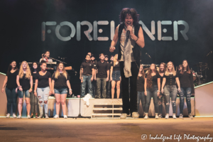Frontman Kelly Hansen and Foreigner band members performing "I Want to Know What Love Is" with the local Sedalia high school choir at the Missouri State Fair's Pepsi Grandstand on August 16, 2019.
