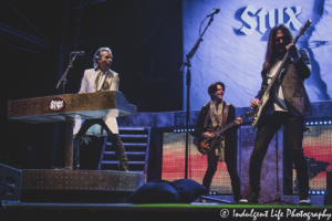 Styx band members Lawrence Gowan, Ricky Phillips and Will Evankovich performing together at Azura Amphitheater in Bonner Springs, KS on June 25, 2021.