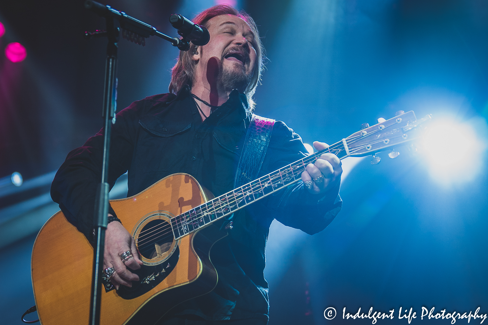 Playing the acoustic guitar an singing the hit song "I'm Gonna Be Somebody" is Travis Tritt at Ameristar Casino's Star Pavilion in Kansas City, MO on December 3, 2021.