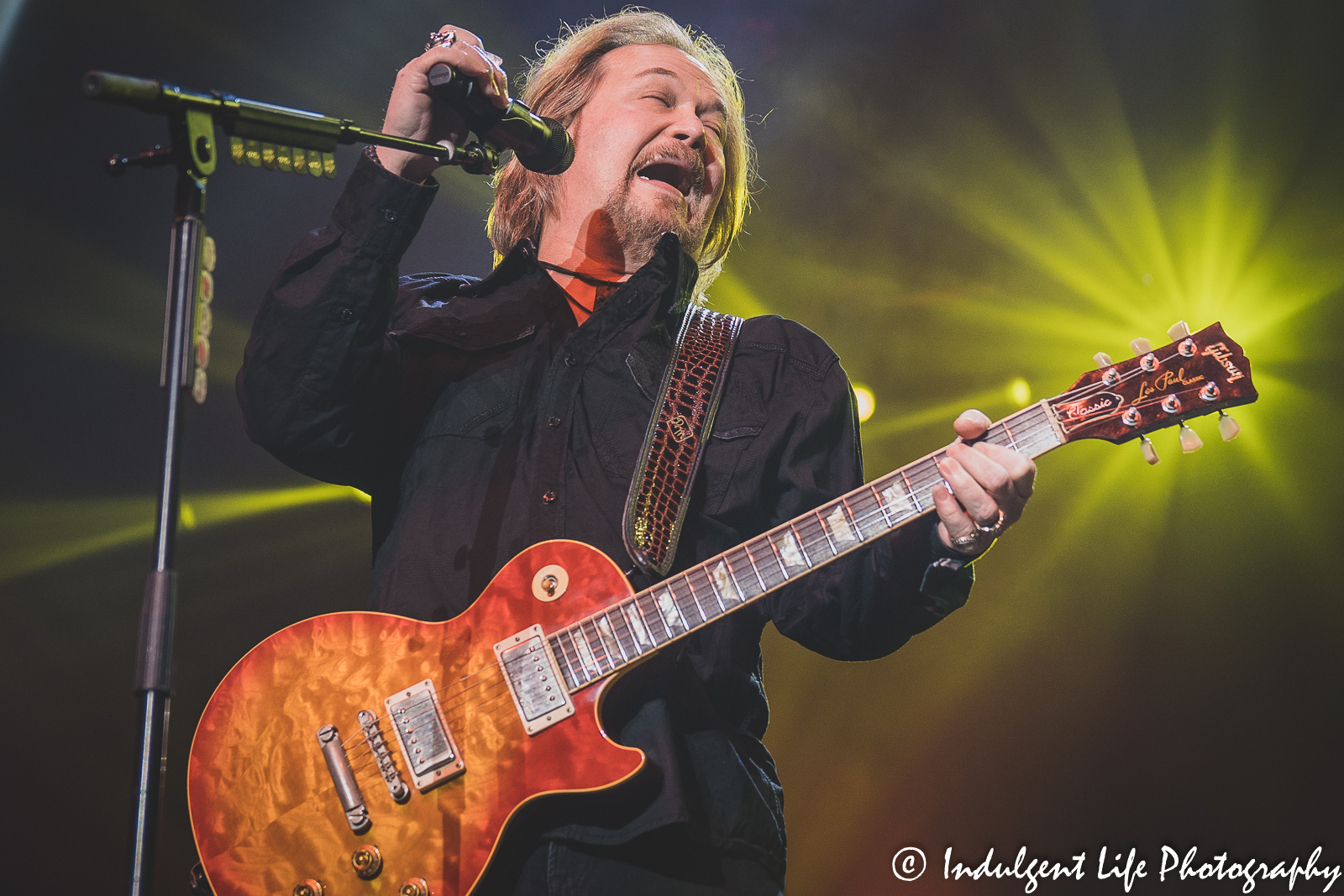 Belting out a big note is Travis Tritt as he performs "Put Some Drive in Your Country" for fans at Ameristar Casino Hotel Kansas City on December 3, 2021.