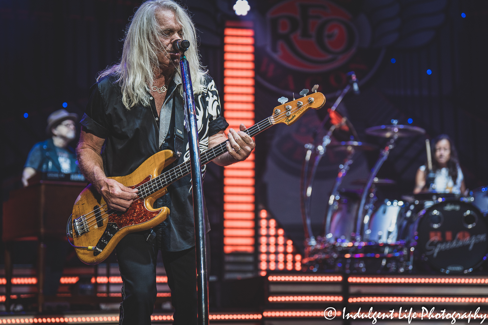 REO Speedwagon bass guitarist Bruce Hall playing live with keyboard player Neal Doughty and drummer Bryan Hitt at Starlight Theatre in Kansas City, MO on June 14, 2022.