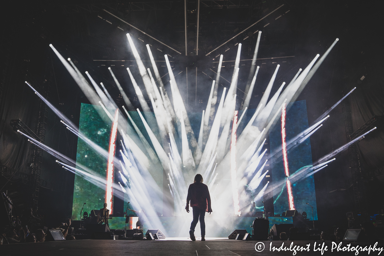 Def Leppard lead singer Joe Elliot walking into the light during a performance of "Let It Go" at Kauffman Stadium in Kansas City, MO on July 19, 2022.