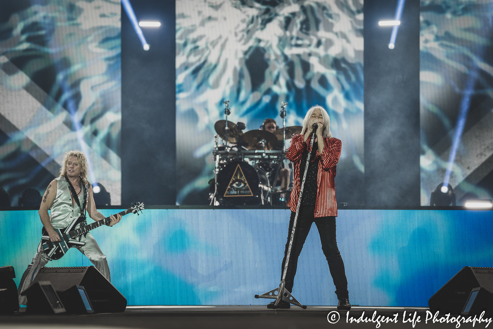 Def Leppard frontman Joe Elliot opening the headlining set with bass player Rick Savage and drummer Rick Allen during the Kauffman Stadium concert in Kansas City, MO on July 19, 2022.