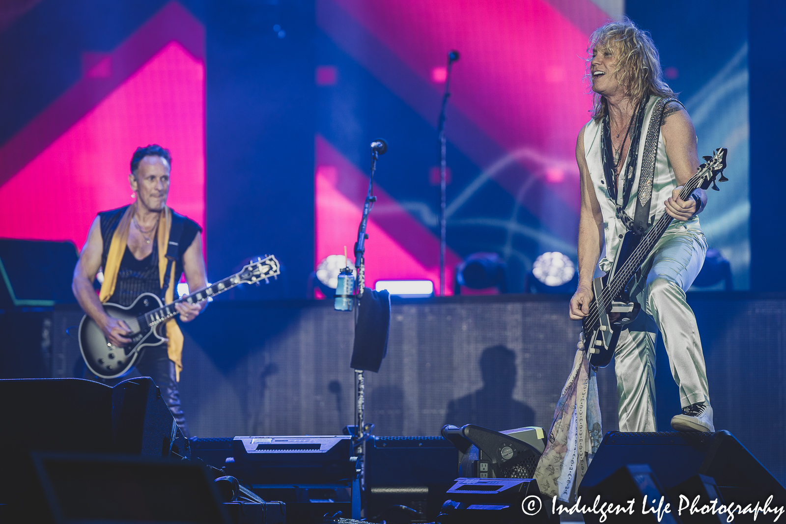Def Leppard guitarist Vivian Campbell and bass player Rick Savage performing live together at Kauffman Stadium in Kansas City, MO on July 19, 2022.