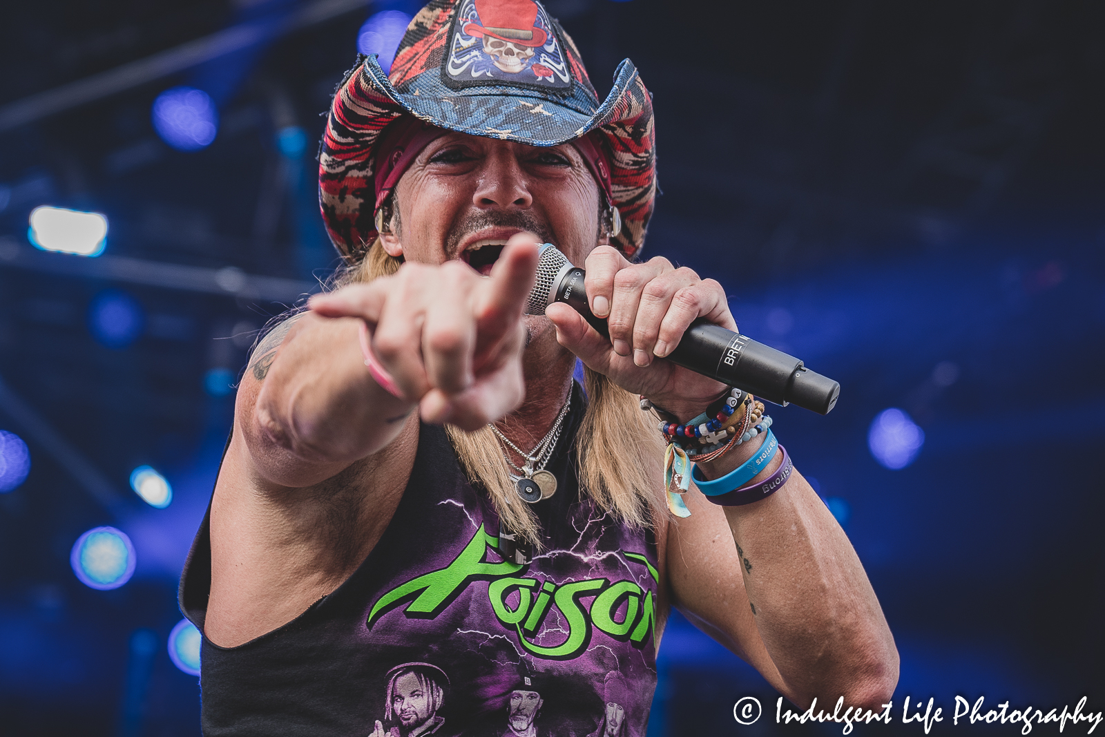 Poison lead singer Bret Michaels pointing to the camera during his live stadium tour performance at Kauffman Stadium in Kansas City, MO on July 19, 2022.