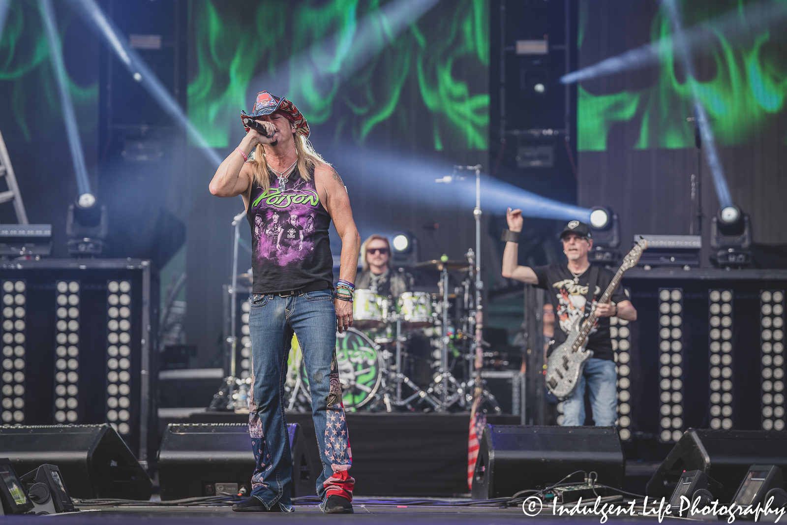 Bret Michaels performing live with Poison members Bobby Dall and Rikki Rockett during the stadium tour concert at Kauffman Stadium in Kansas City, MO on July 19, 2022.