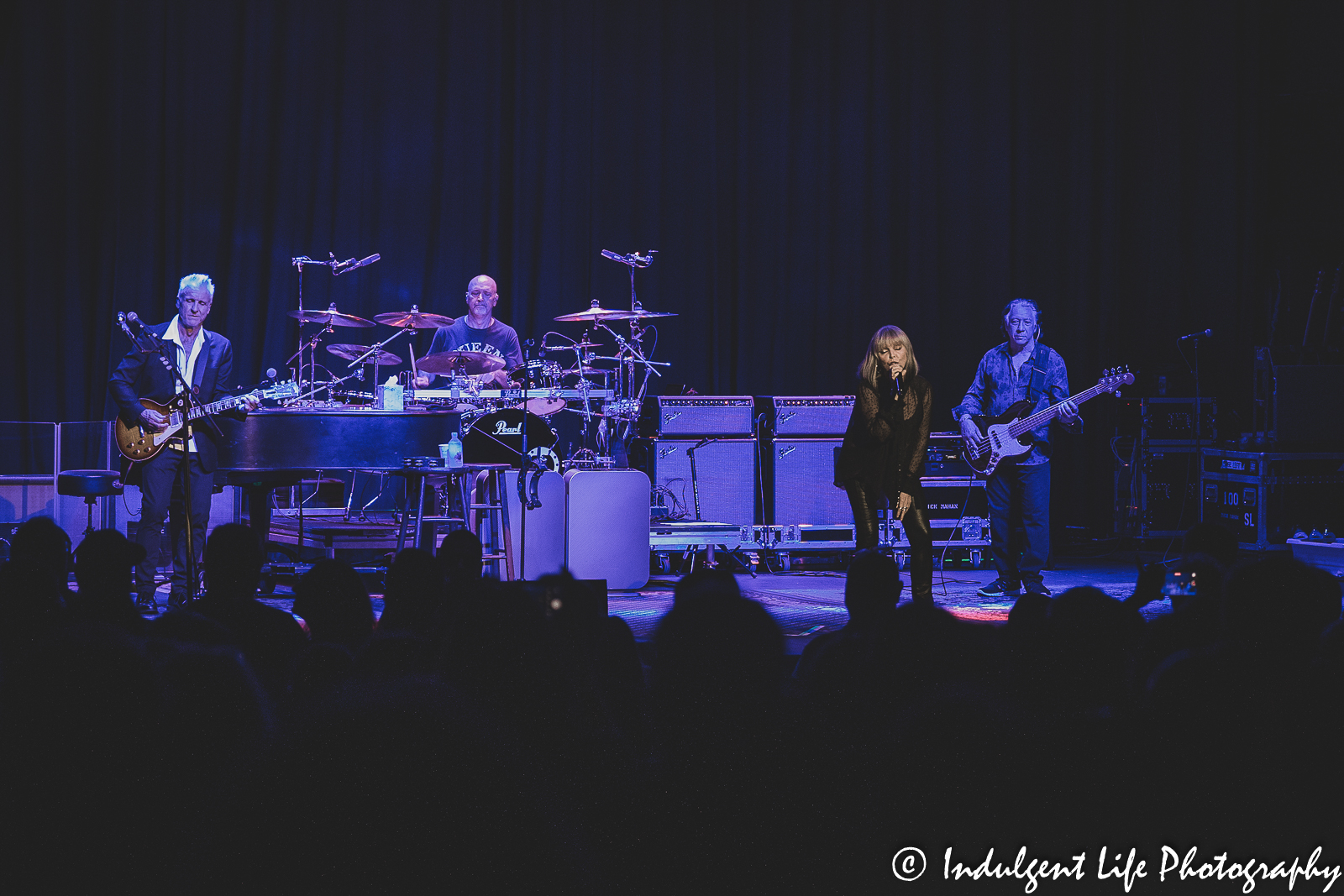 Pat Benatar & Neil Giraldo performing live with bass guitarist Mick Mahan and drummer Myron Grombacher at Uptown Theater in Kansas City, MO on August 2, 2022.