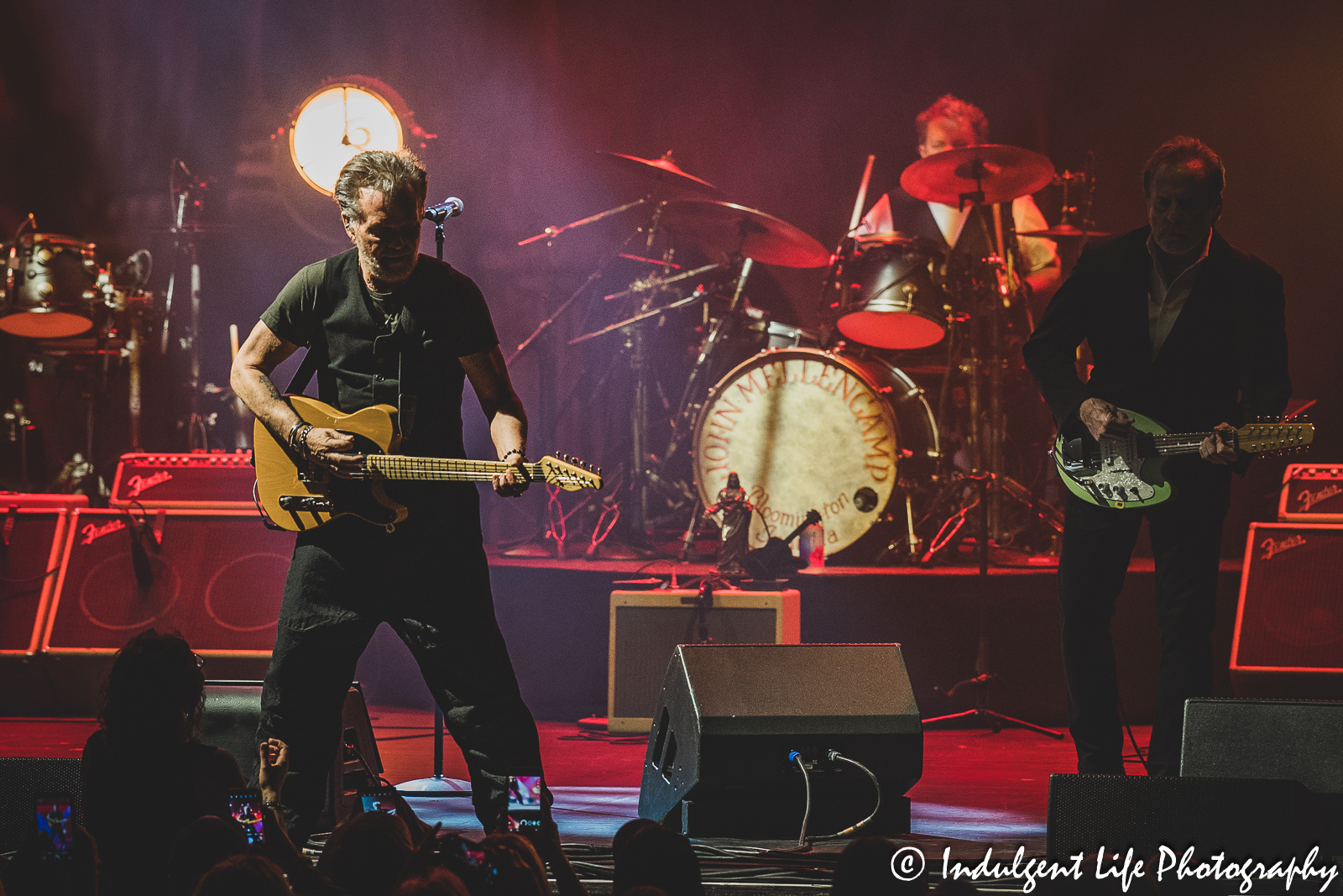 John Mellencamp performing "Paper in Fire" with drummer Dane Clark and guitarist Mike Wanchic at The Midland Theatre in downtown Kansas City, MO on April 4, 2023.