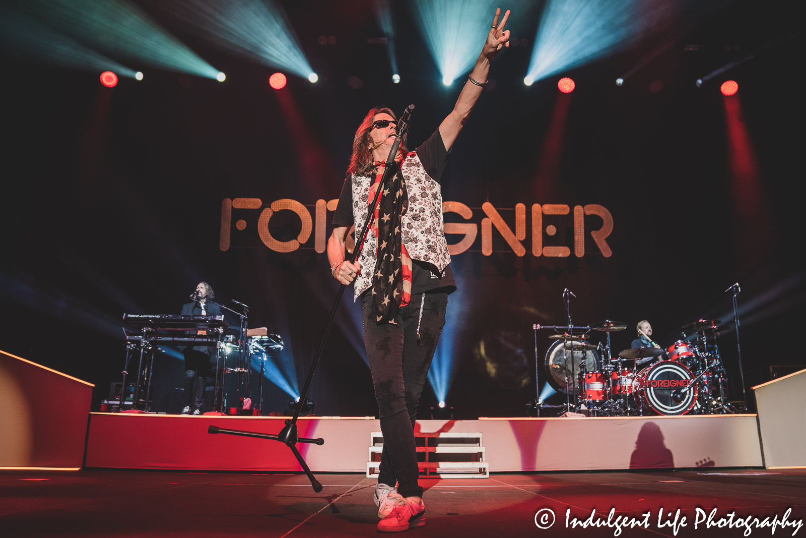 Frontman Kelly Hansen of Foreigner performing "Double Vision" with keyboard player Michael Bluestein and drummer Chris Frazier at Hartman Arena in Park City, KS on April 30, 2023.