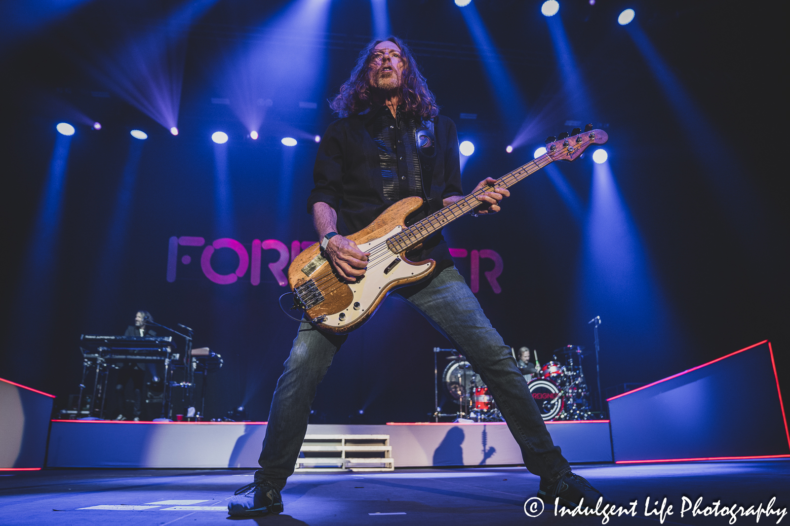 Foreigner bass guitarist Jeff Pilson performing with keyboard player Michael Bluestein and drummer Chris Frazier at Hartman Arena in Park City, KS on April 30, 2023.