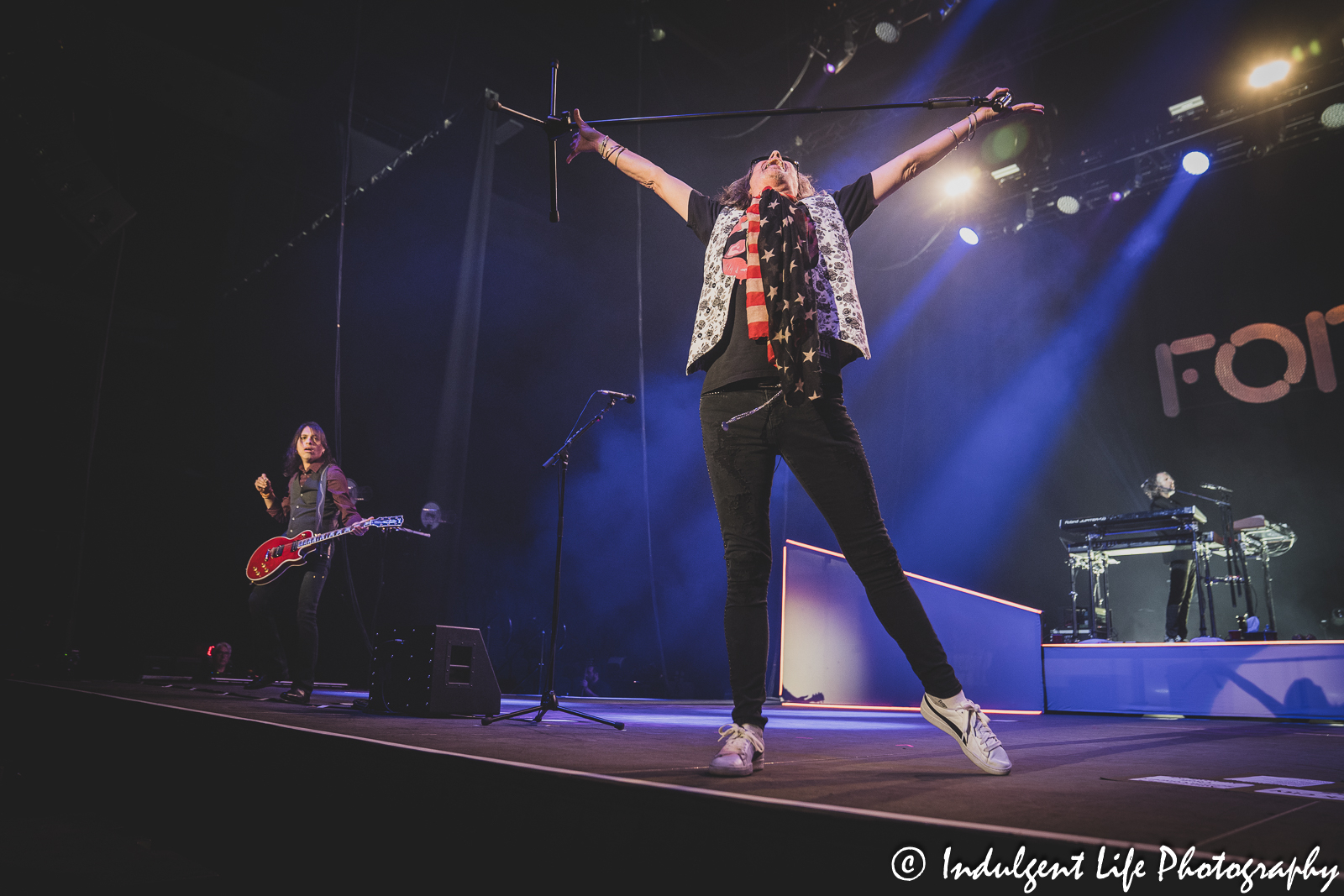 Foreigner lead singer Kelly Hansen performing with guitarist Luis Maldonado and keyboard player Michael Bluestein at Hartman Arena in Park City, KS on April 30, 2023.