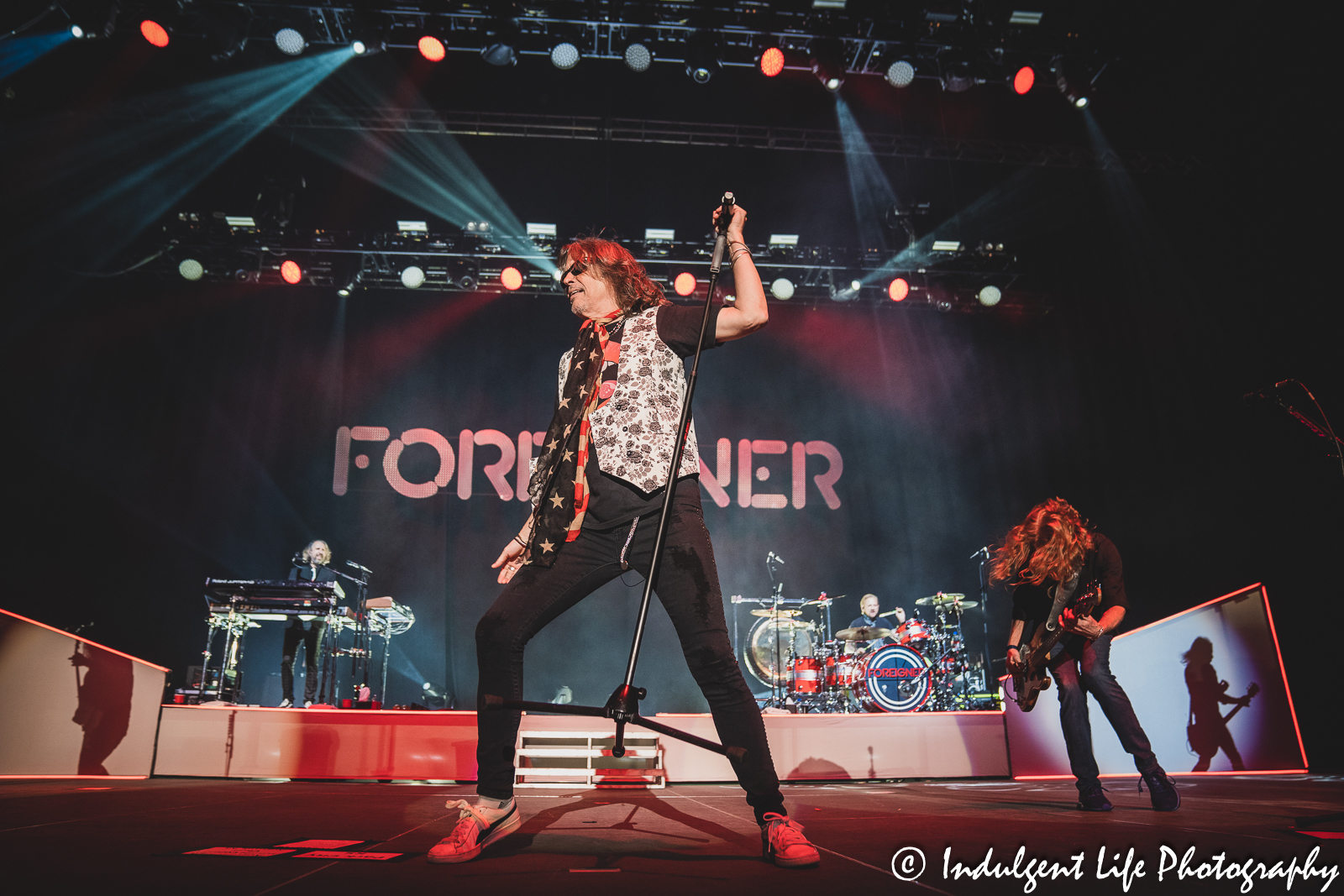 Foreigner lead vocalist Kelly Hansen performing with bass player Jeff Pilson, keyboardist Michael Bluestein and drummer Chris Frazier at Hartman Arena in Park City, KS on April 30, 2023.