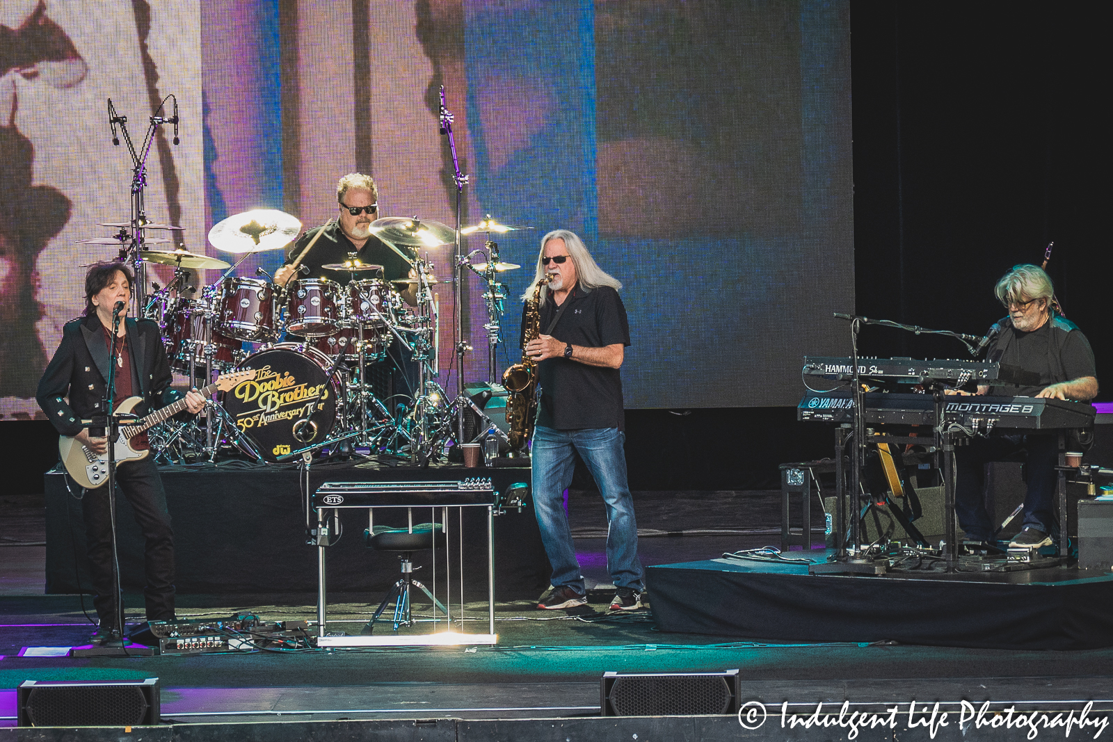 Founding member John McFee of The Doobie Brothers and classic member Michael McDonald alongside touring members Marc Russo on saxophone and Ed Toth on drums at Starlight Theatre in Kansas City, MO on June 14, 2023.