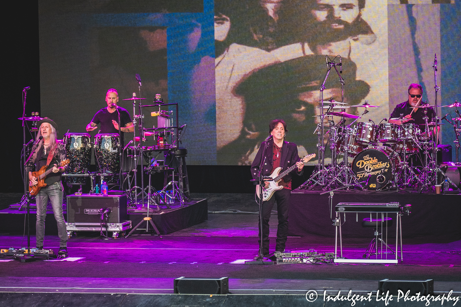 Doobie Brothers founding members Patrick Simmons and John McFee live on stage with percussionist Marc Quiñones and drummer Ed Toth (drums) at Starlight Theatre in Kansas City, MO on June 14, 2023.