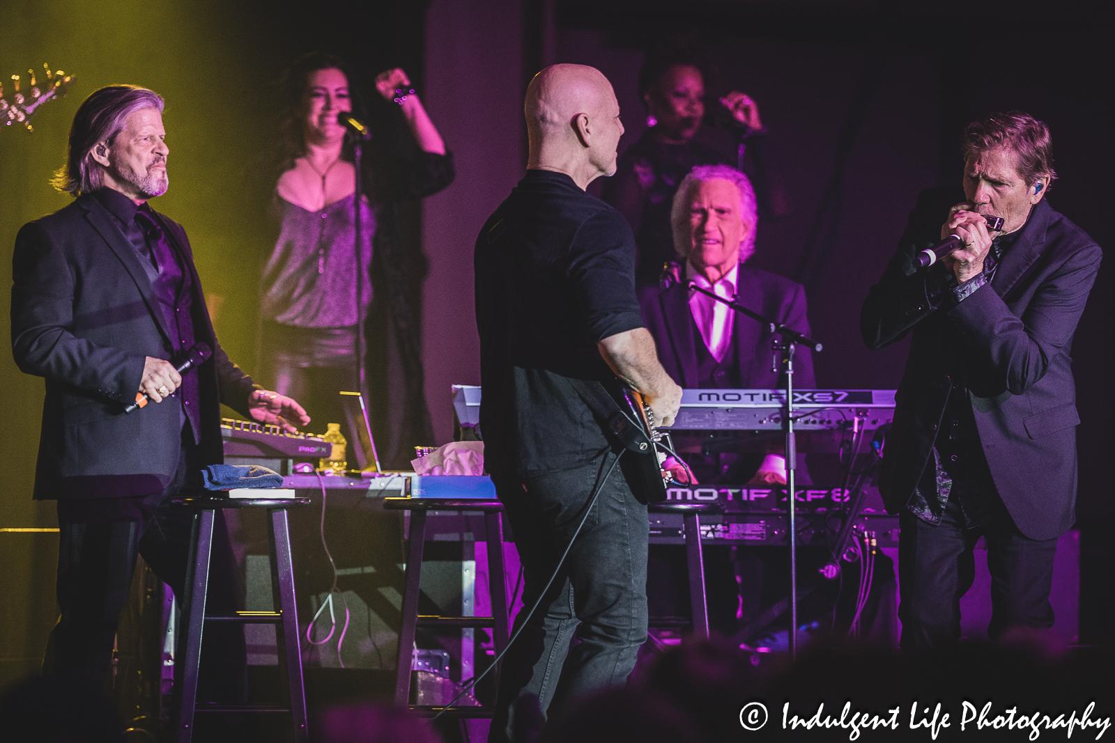 Keyboardist Tim Lee playing the harmonica along with Bill Medley, Bucky Heard and band members of The Righteous Brothers at Prairie Band Casino in Mayetta, KS on June 29, 2023.