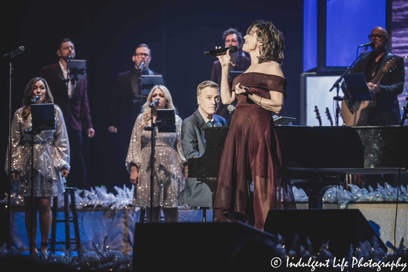 Amy Grant singing live while Michael W. Smith plays the piano during their Christmas concert at Music Hall in downtown Kansas City, MO on November 30, 2023.