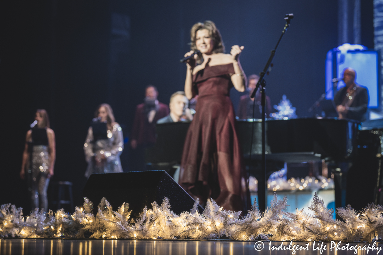 Amy Grant performing live while Michael W. Smith plays the piano during their Christmas show at Music Hall in downtown Kansas City, MO on November 30, 2023.