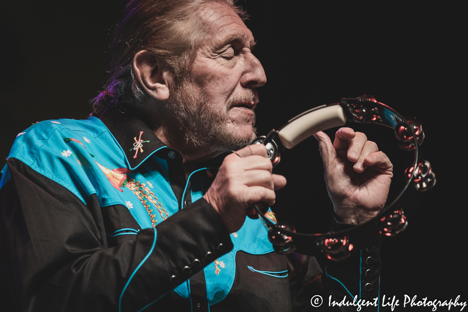 The Marshall Tucker Band frontman and founding member Doug Gray playing the tambourine live at Ameristar Casino's Star Pavilion in Kansas City, MO on December 1, 2023.