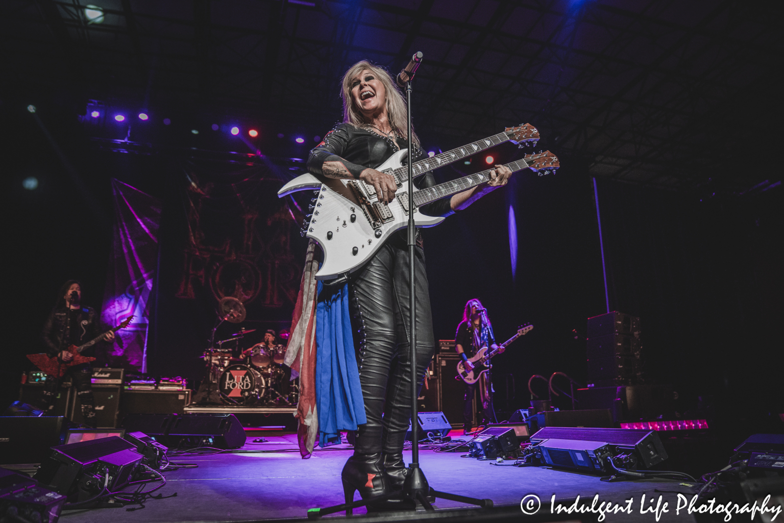 Lita Ford singing and playing her double-headed guitar live with her band at Hy-Vee Arena in Kansas City, MO on March 22, 2024.