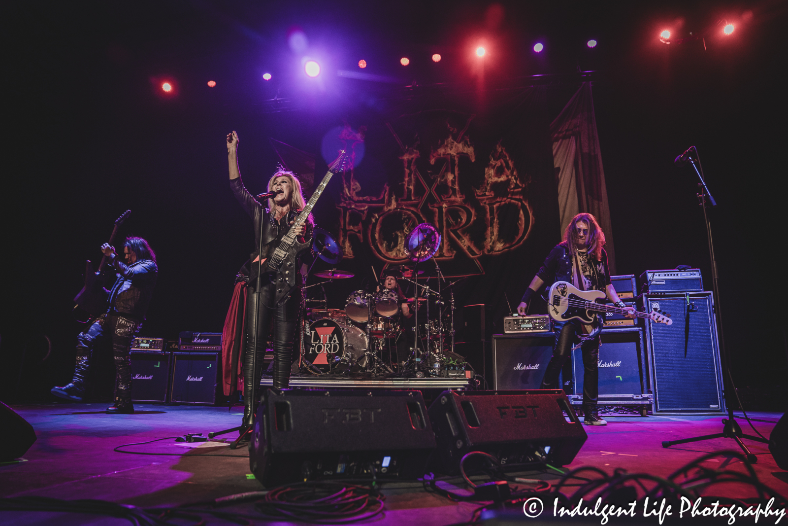 Lita Ford and her band members performing together at Hy-Vee Arena in Kansas City, MO on March 22, 2024.