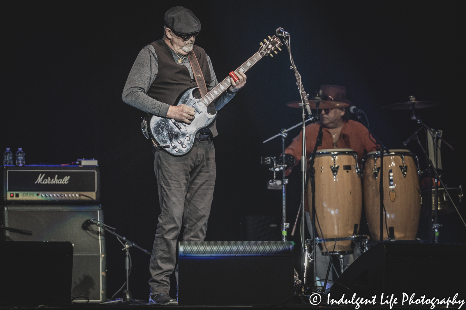 Foghat bass guitar player Bryan Bassett and tour percussionist performing together at Ameristar Casino in Kansas City, MO on March 15, 2025.