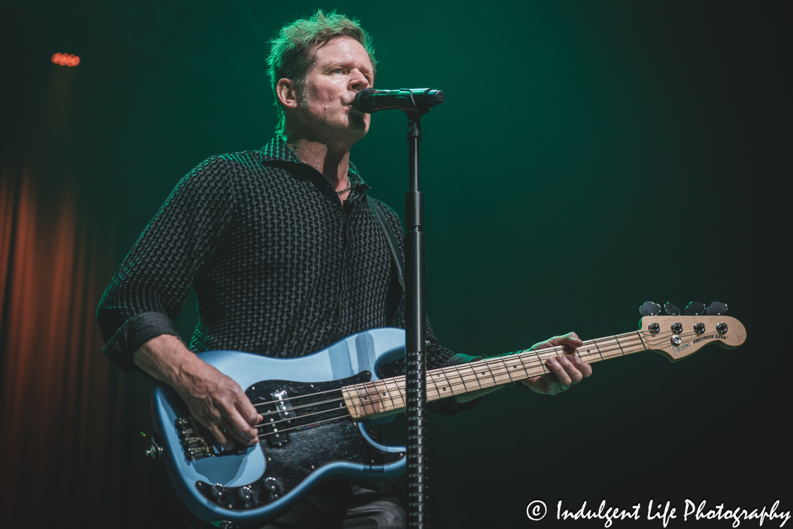 Shooting Star frontman Todd Pettygrove playing the bass guitar live at Ameristar Casino's Star Pavilion in Kansas City, MO on April 26, 2025.