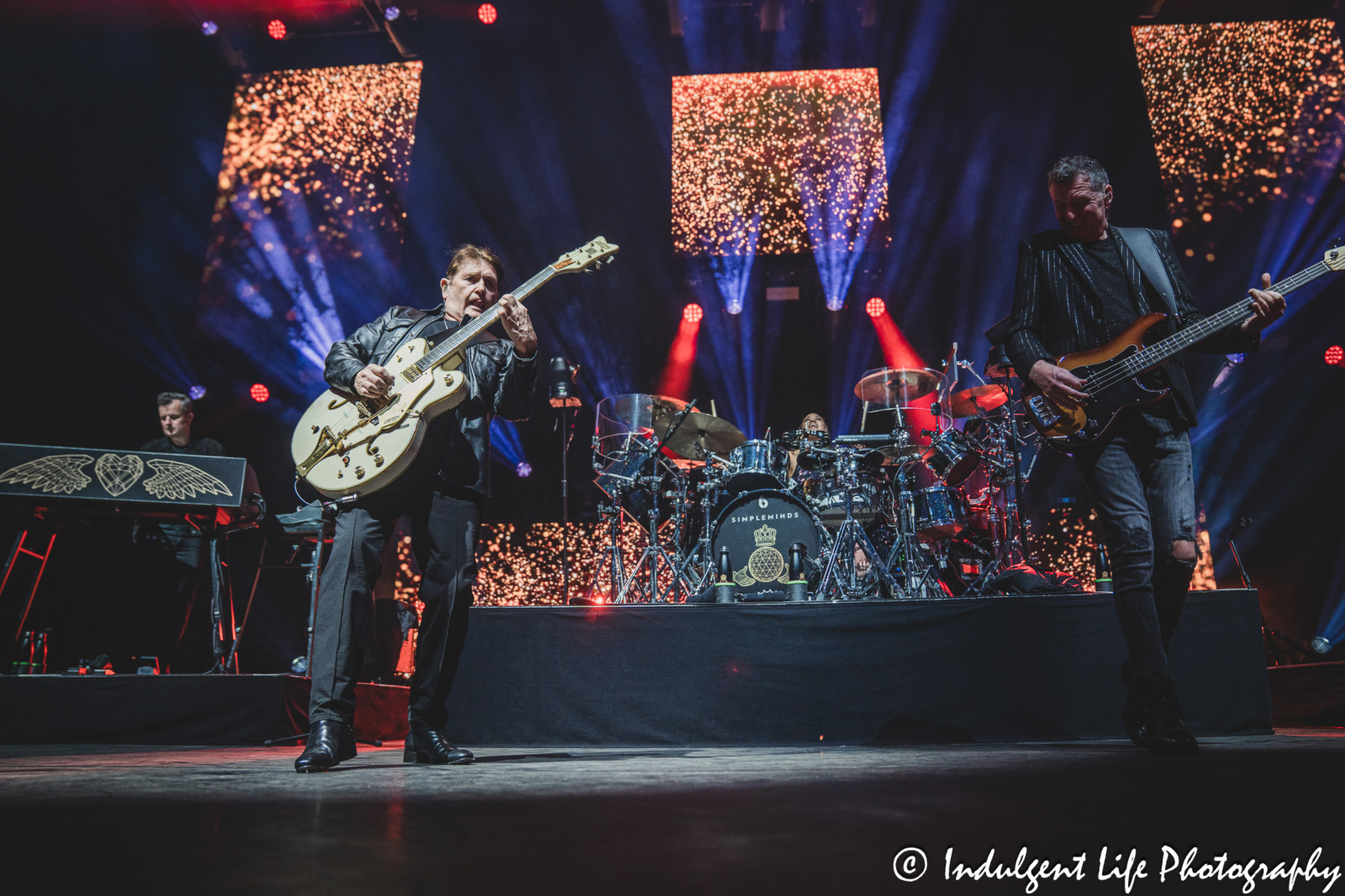 Simple Minds band members Charlie Burchill, Ged Grimes, Erik Ljunggren and Cherisse Osei performing "Glittering Prize" with on the band's "Alive & Kicking" tour at Hollywood Casino Amphitheater in Maryland Heights, MO on June 5, 2025.
