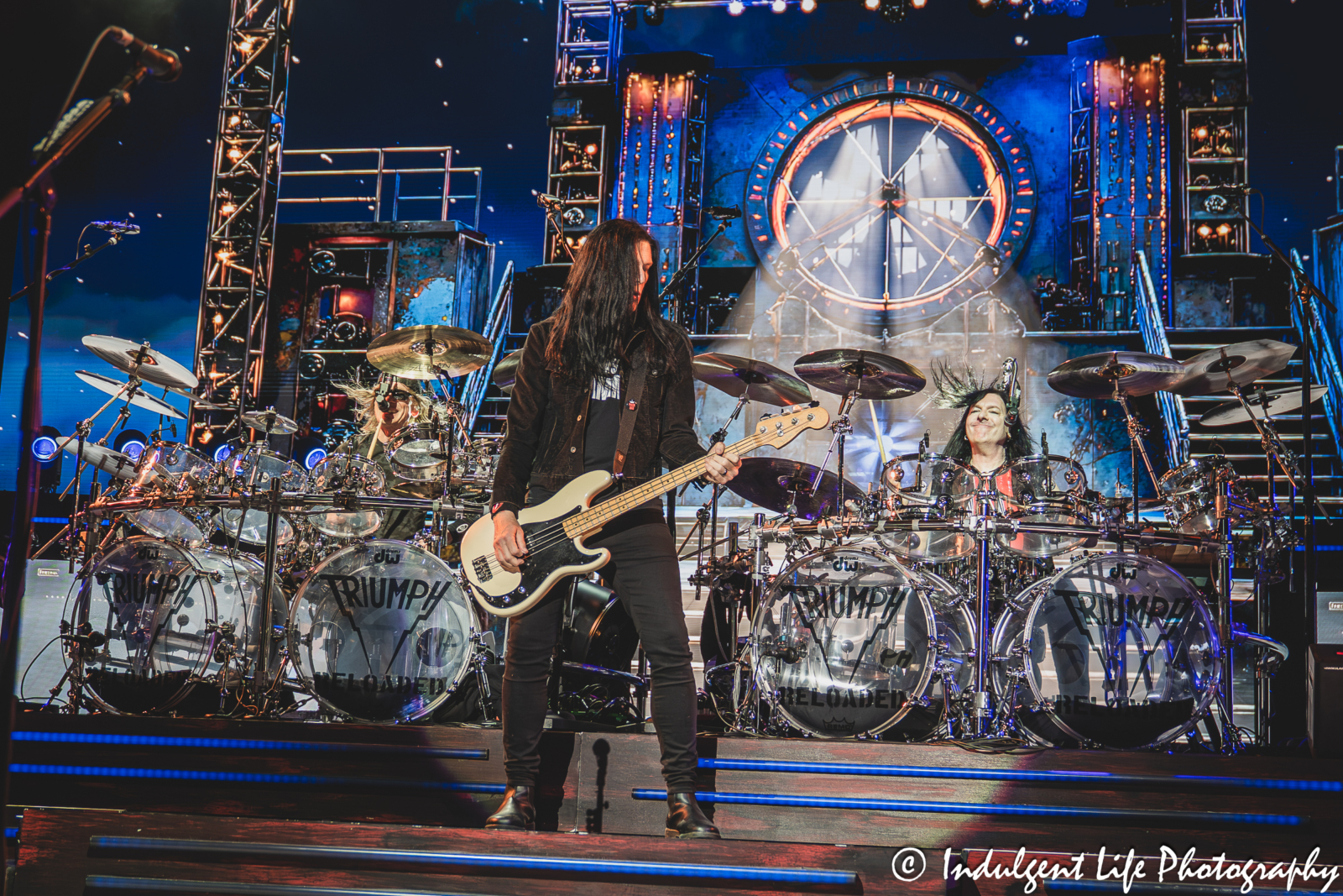 Triumph bass guitarist Todd Kerns performing "When the Lights Go Down" with drummer Gil Moore and Brent Fitz at Starlight Theatre in Kansas City, MO on May 16, 2026.